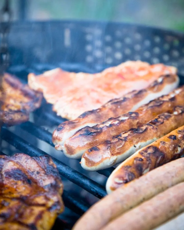 Meats sizzling on a backyard barbecue grill