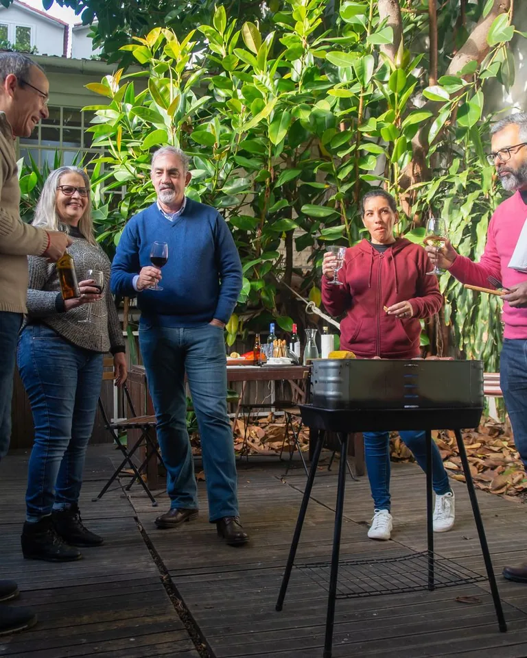 Guests enjoying drinks at a garden BBQ