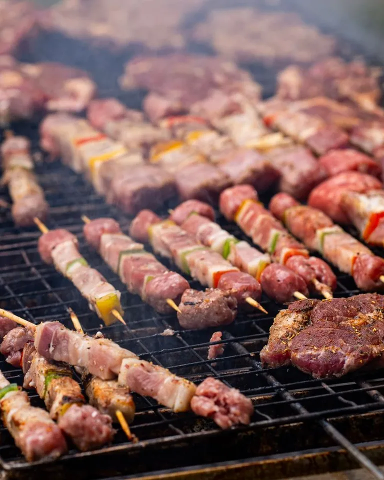 Grilled meat skewers on an outdoor barbecue
