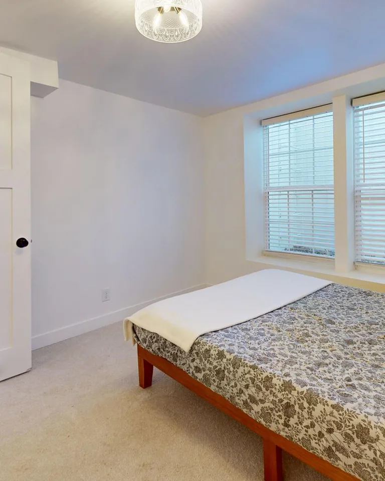 Inviting basement guest bedroom with layered bedding
