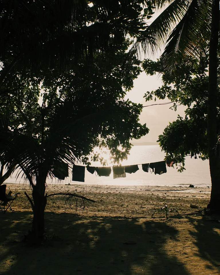 Laundry hanging with a tropical beach silhouette