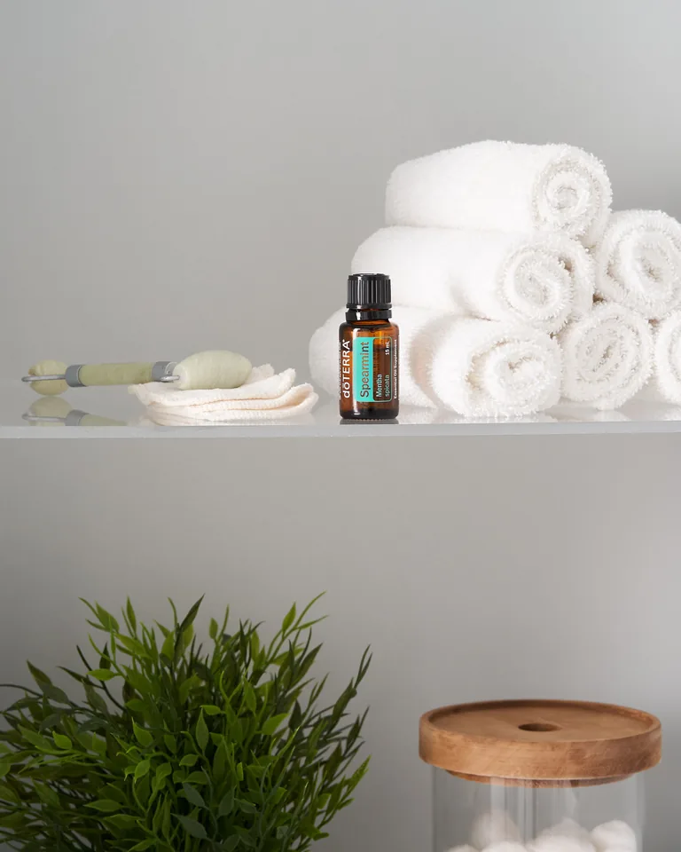 Neatly folded white towels on glass shelves in a spa