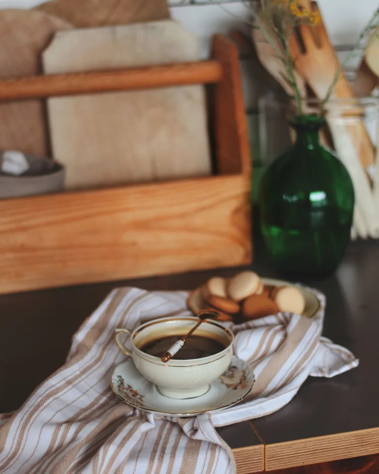 Warm coffee setup with a ceramic cup and rustic kitchen decor