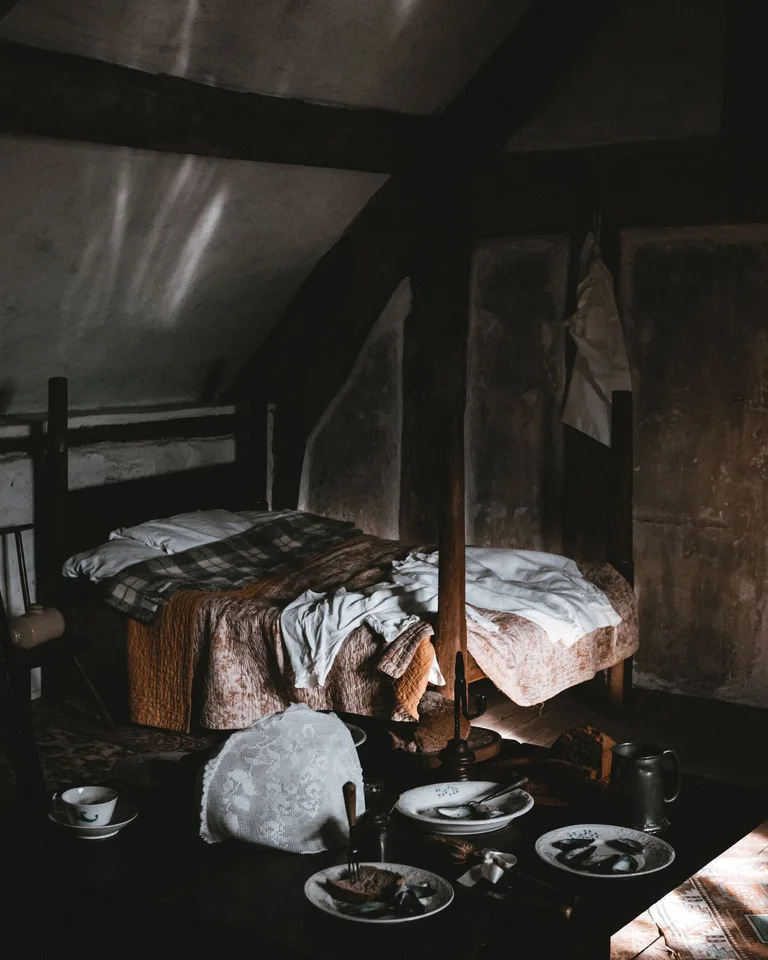 Rustic bedroom with vintage furniture dressed in natural linen bedding