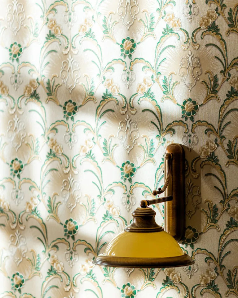 Vintage wall sconce on floral wallpaper with natural light