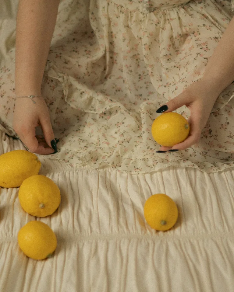 Cozy still life with lemons resting on floral vintage fabric