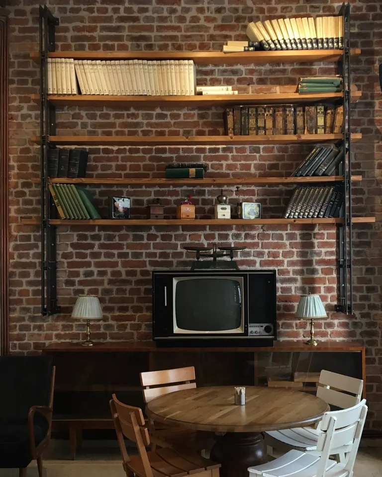 Vintage interior with bookshelves on a brick wall