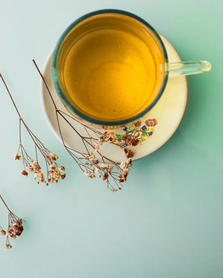 Glass teacup with dried flowers on a table