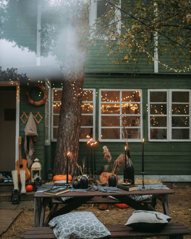 Backyard decorated with Halloween decorations along a walking path at dusk