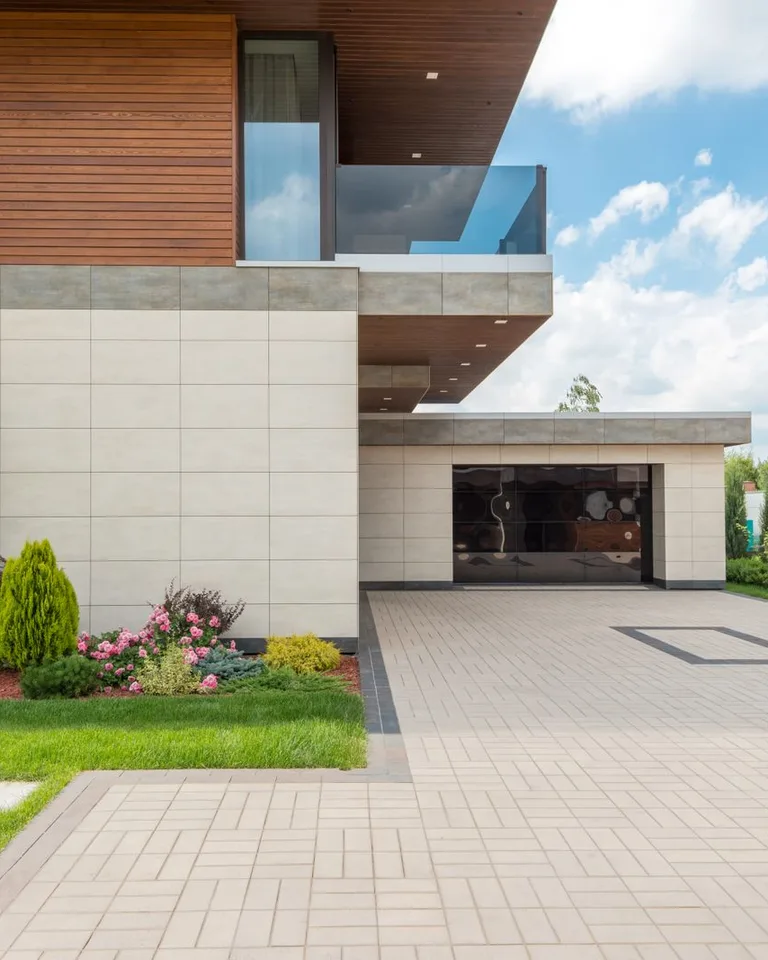 Modern minimalist house with a spacious driveway and landscaped garden