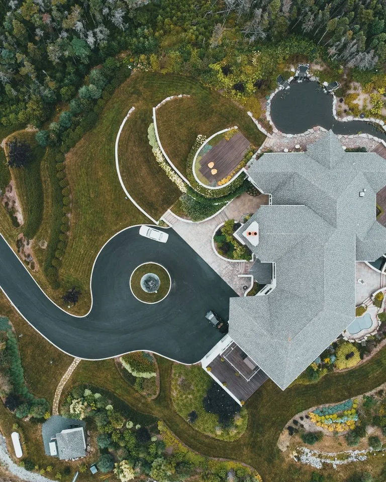 Luxury mansion with a landscaped garden and winding driveway