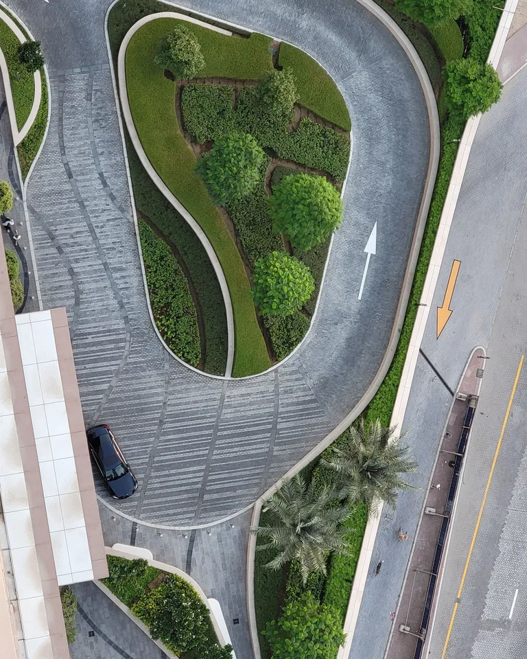 Aerial view of a circular road surrounded by lush greenery