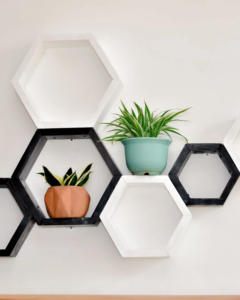 Floating shelves styled with small decor in an entryway