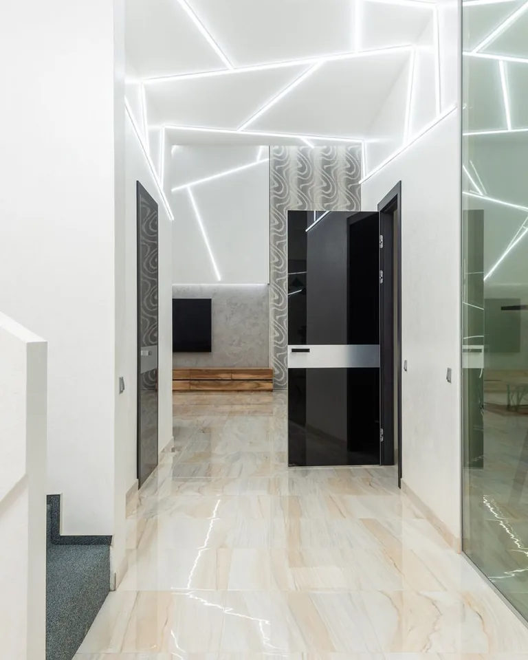 Warmly lit hallway with wall lamps