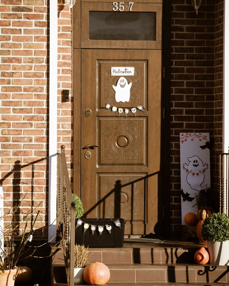 Warm wooden entrance adorned with pumpkins for fall