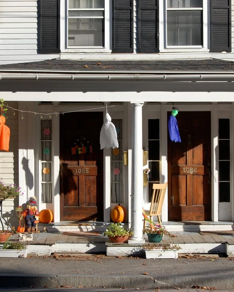 Cute Halloween decorated front porch with pumpkins