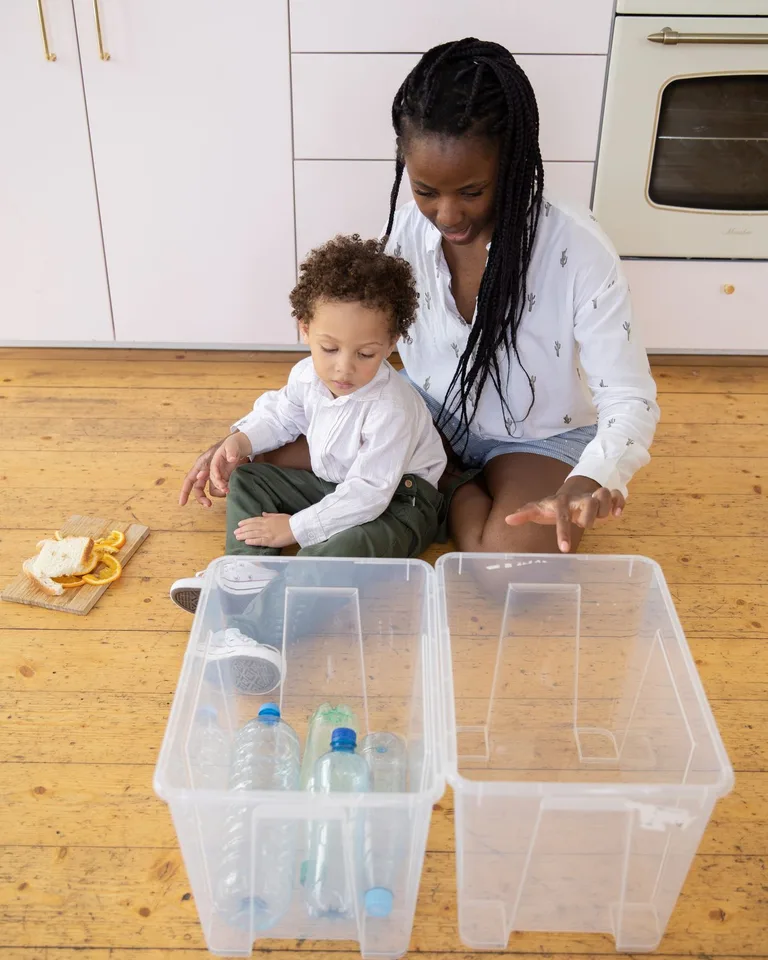 Stacked clear plastic storage bins in an organized space