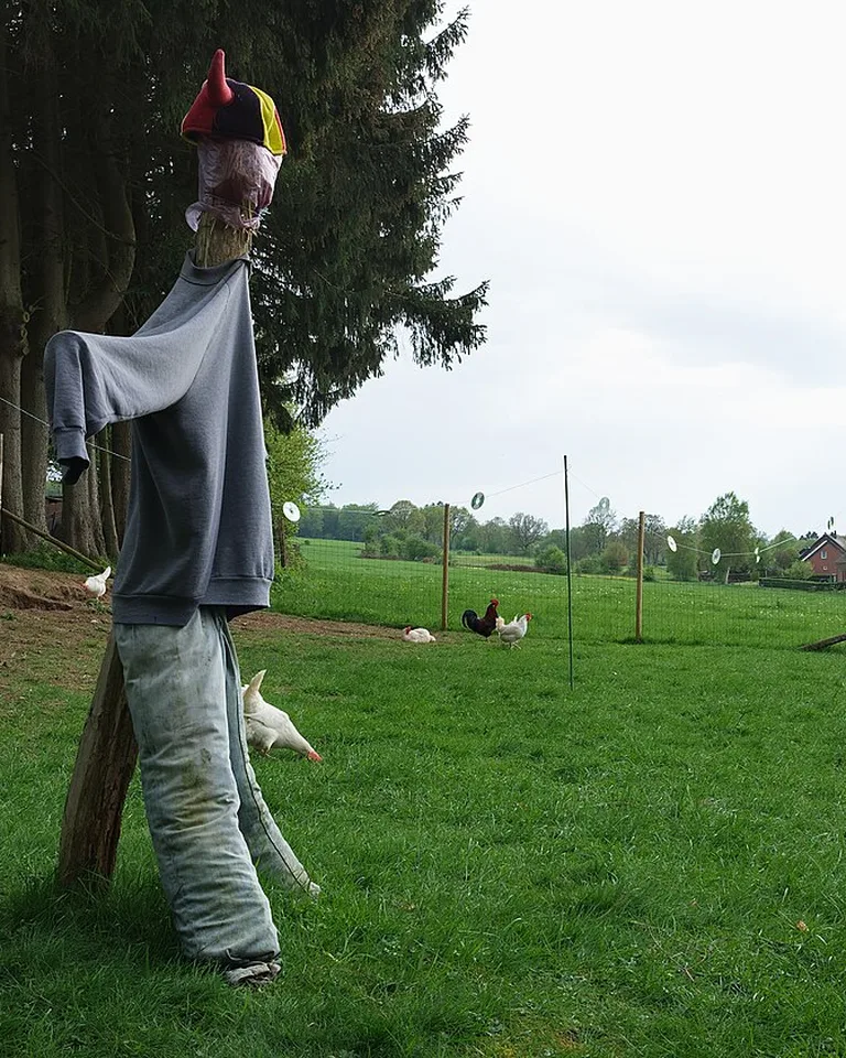 Friendly scarecrows sitting on hay bales for Halloween