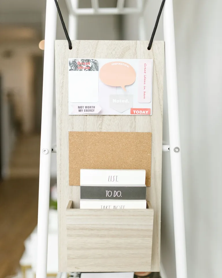 Decorative wall organizer holding cards, notes, and small items