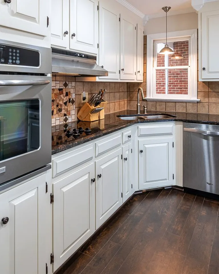 Organized kitchen cabinets with stacked dishes and shelf risers