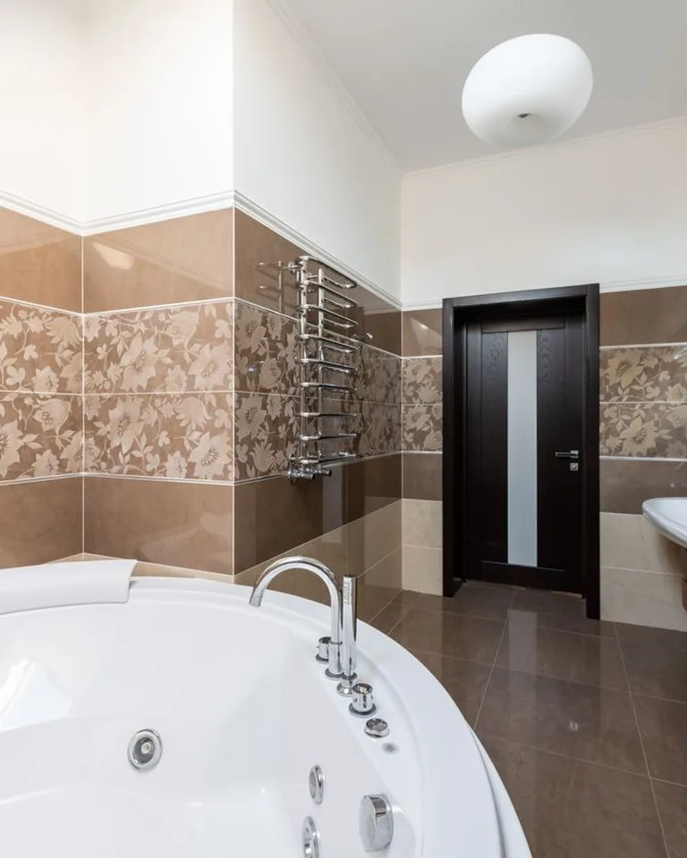 Tidy small bathroom with a rolling storage cart