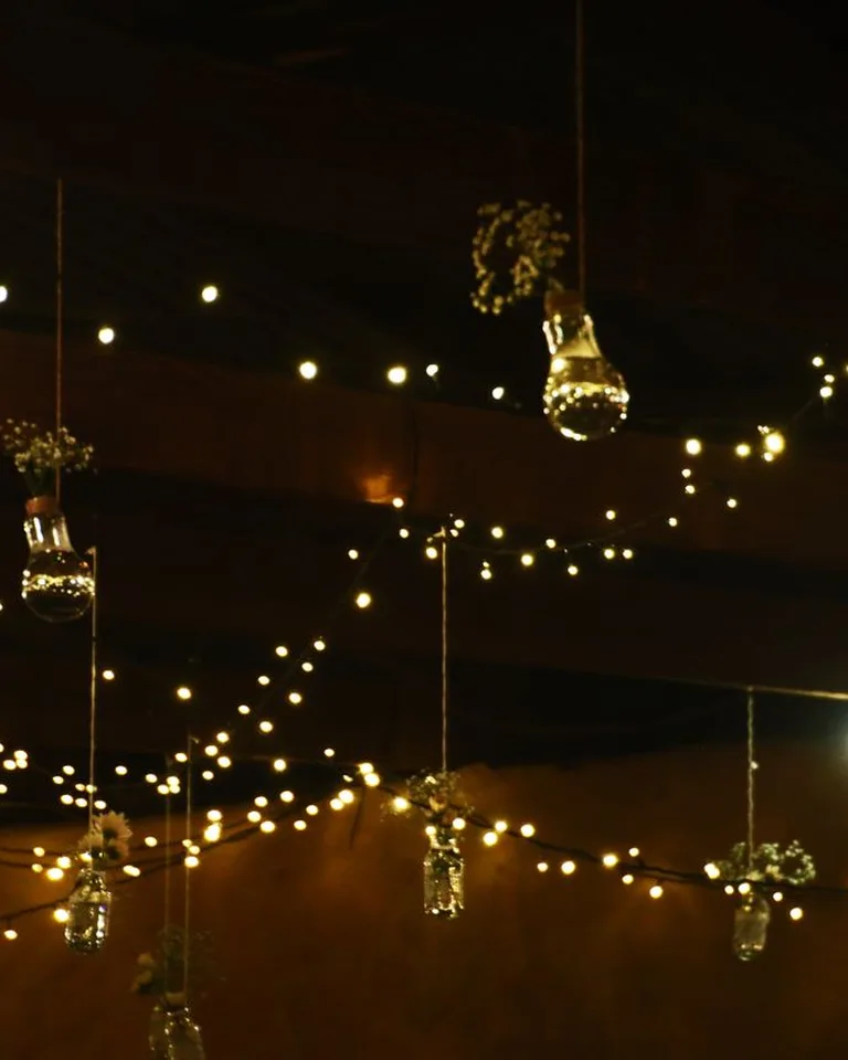 Warm string lights glowing in a backyard at night