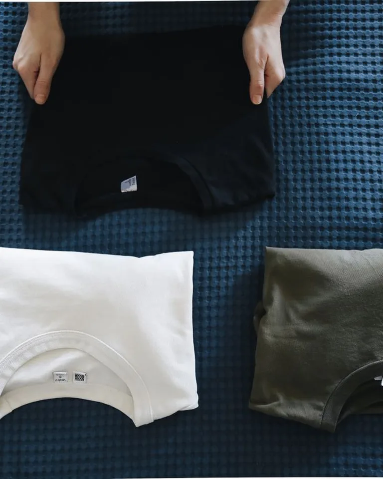 Neatly folded clothes being packed for vacuum storage bags