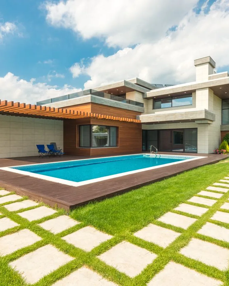 Backyard swimming pool under a clear blue sky