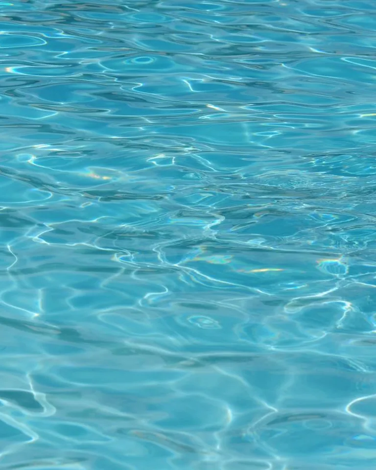 Clear turquoise pool water with gentle ripples