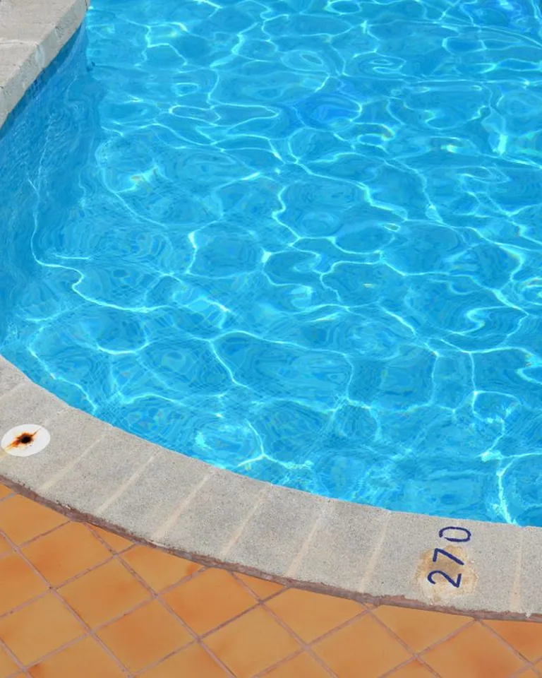 Section of a refreshing swimming pool under bright daylight