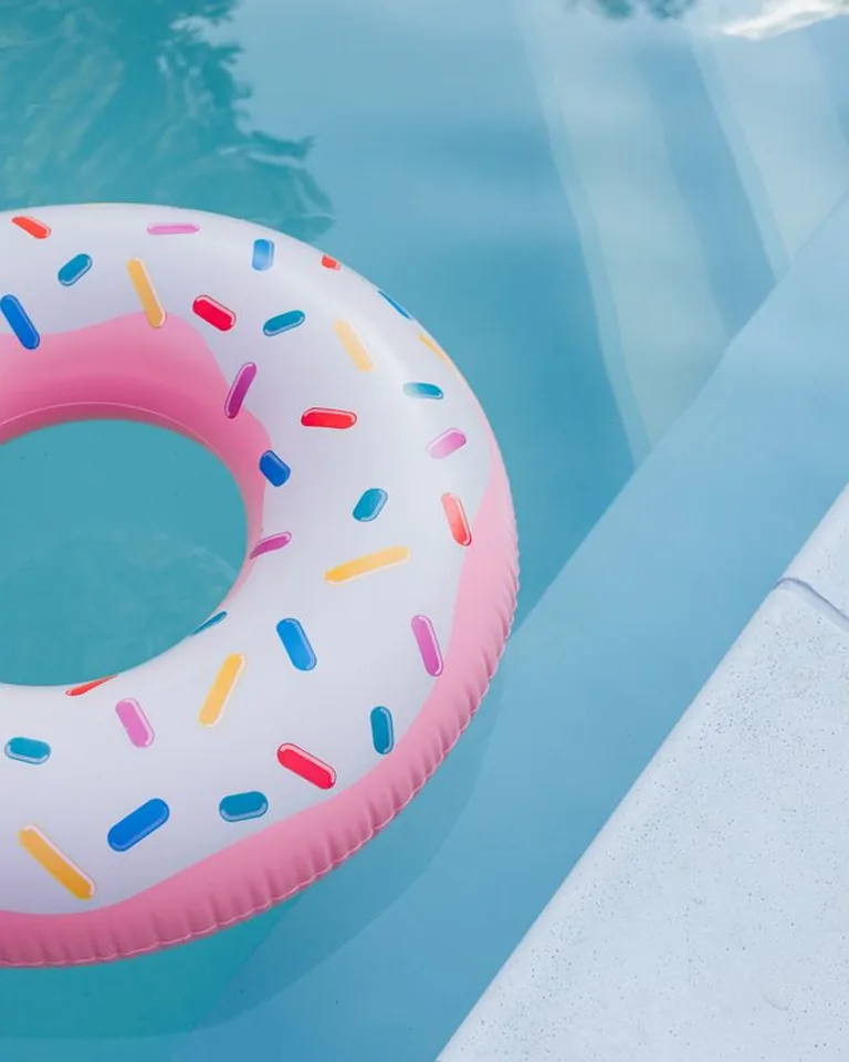 Donut-shaped inflatable floater in a clear swimming pool