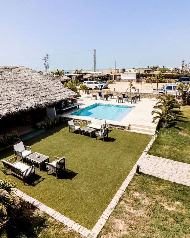 Swimming pool at a tropical resort with a nipa hut