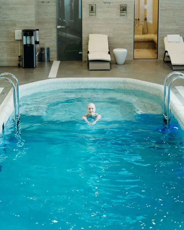 Adult relaxing in an indoor swimming pool