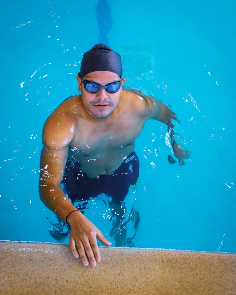 Swimmer wearing goggles and swim cap in a pool