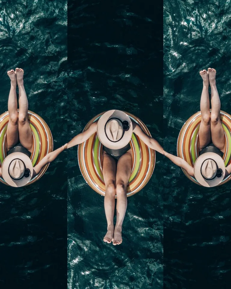 Women floating on colorful inflatables in a swimming pool