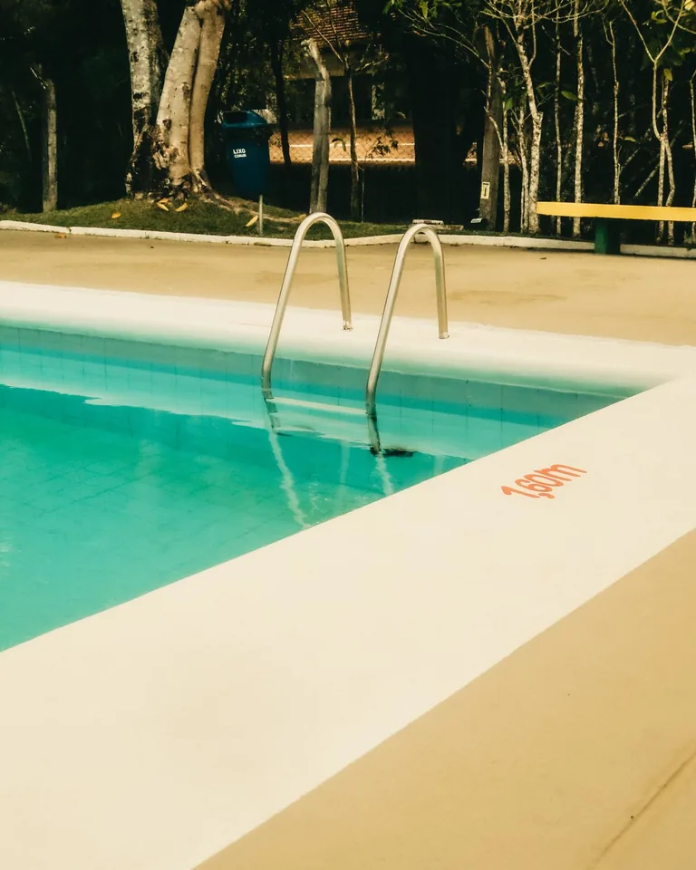 Swimming pool with a ladder and pool sign