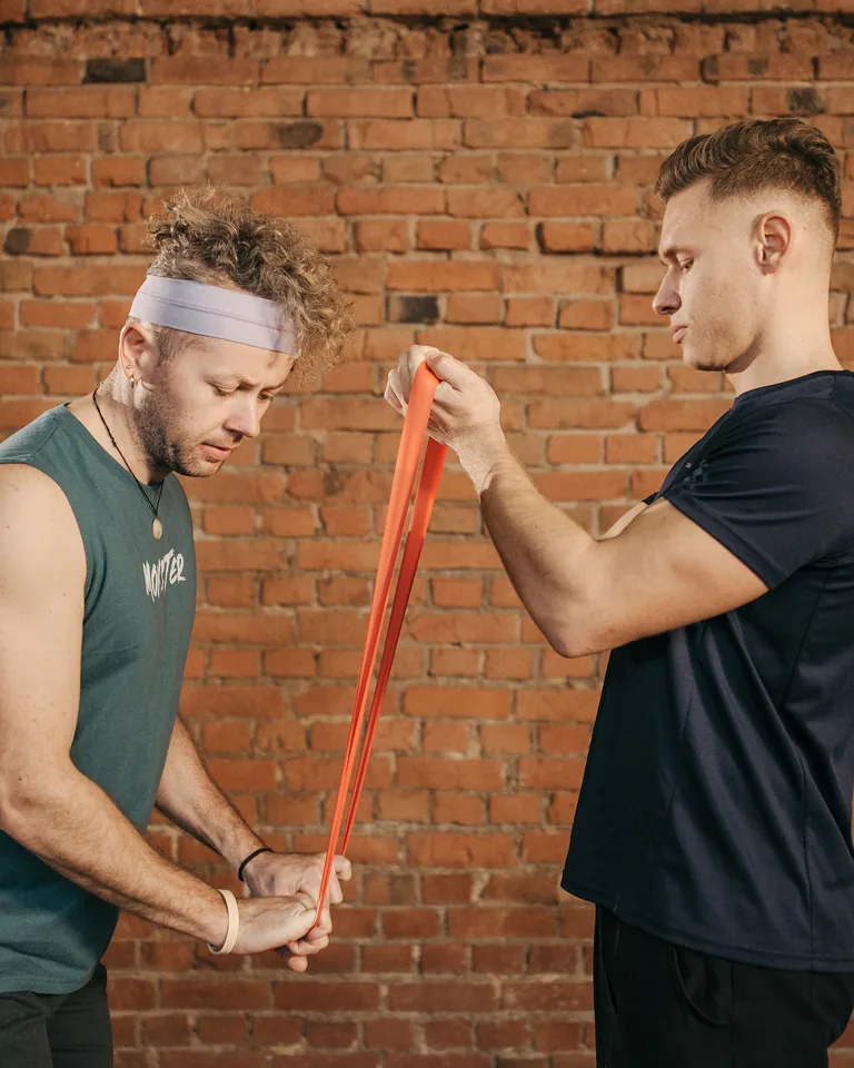 Man doing stretching exercise with a resistance band