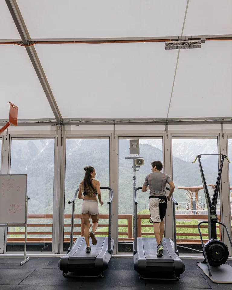Couple running on treadmills in a gym