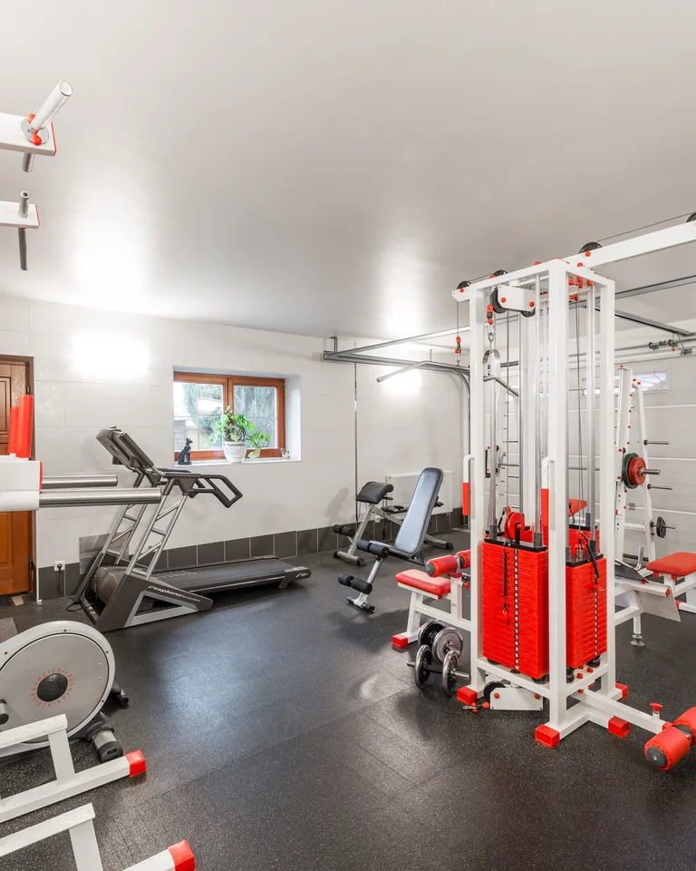 Home gym with equipment set up in a basement