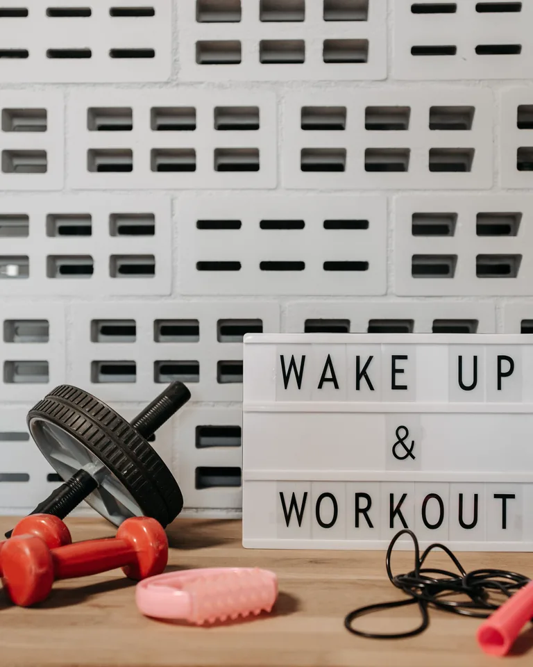 Home gym setup with motivational lightbox and equipment