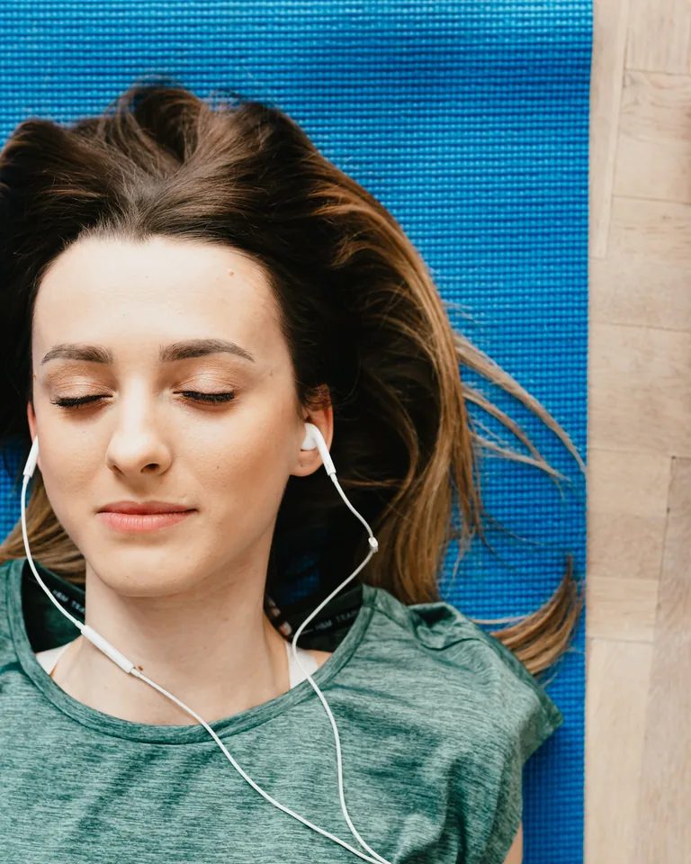 Woman resting on a mat after a home workout