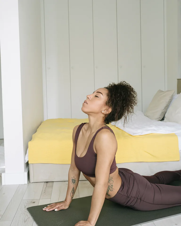 Woman doing yoga exercise indoors