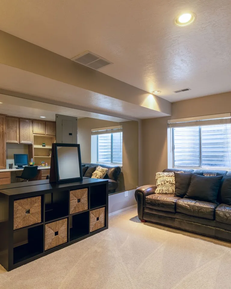 Warm and inviting basement living room with a leather sofa and modern decor