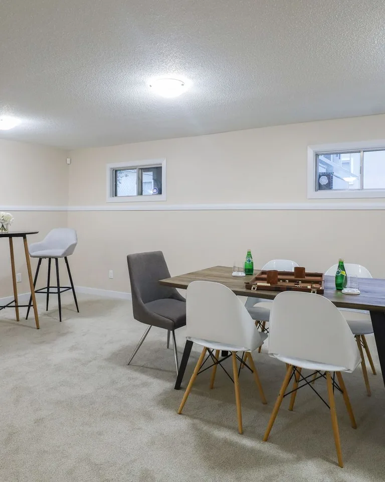 Stylish basement dining and living area with minimalist decor