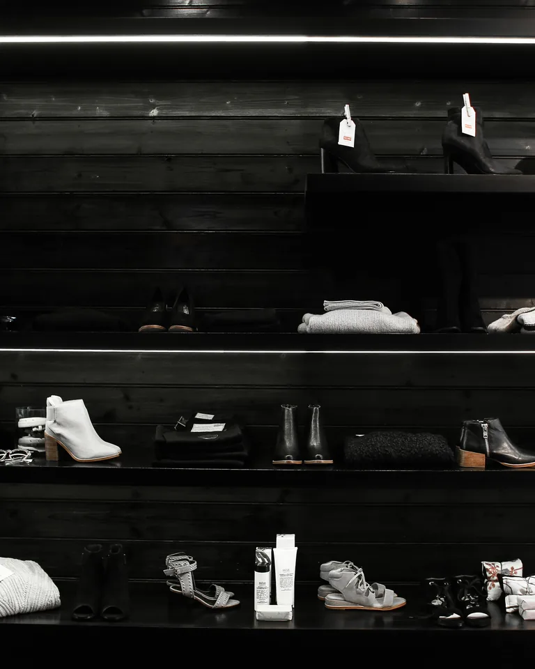 Shoes arranged on shelves in a walk-in closet