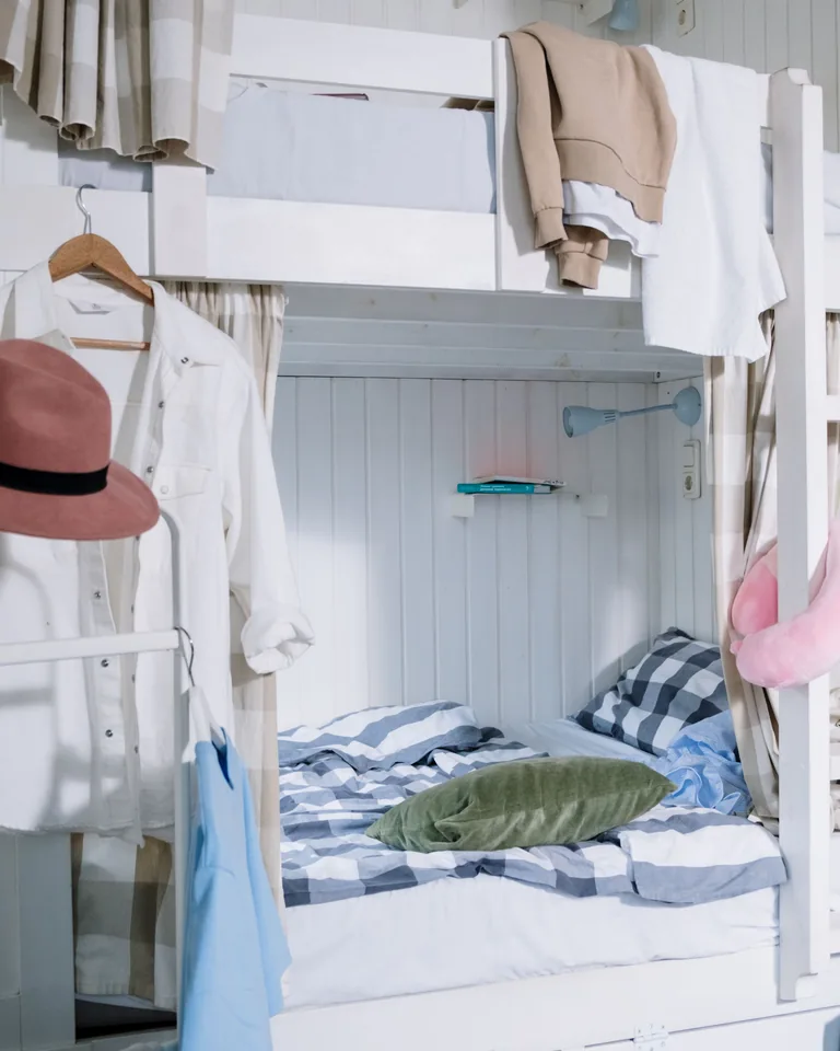 Neatly arranged small room with hanging clothes