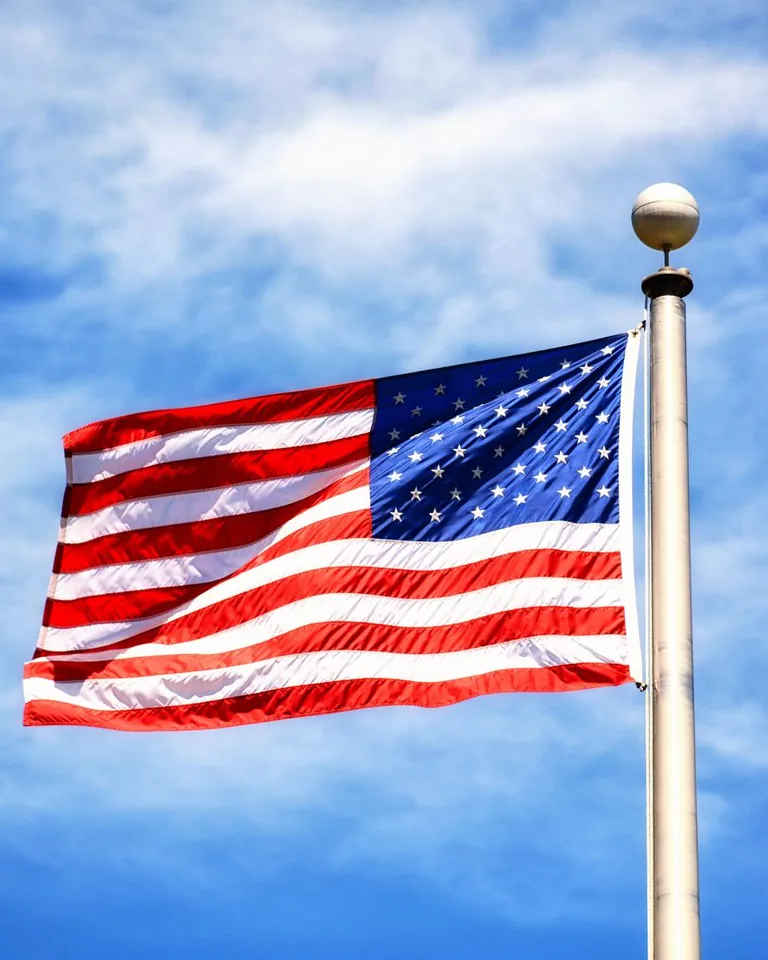 American flag flying against a clear blue sky