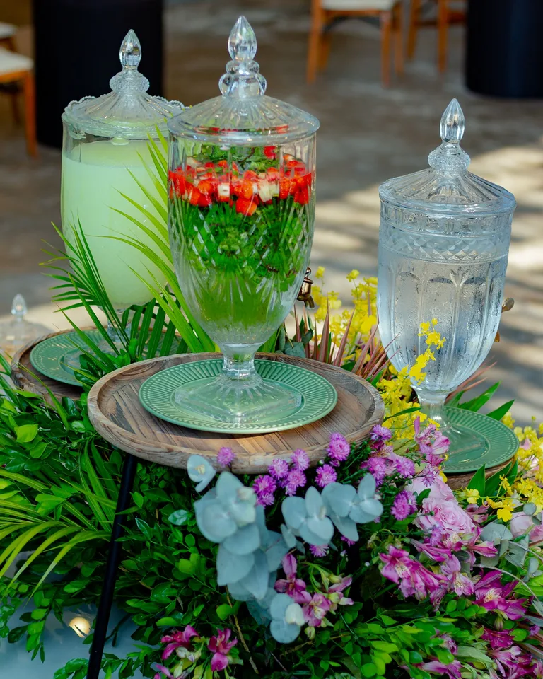 Elegant table setup with glass dispensers and vibrant floral centerpiece