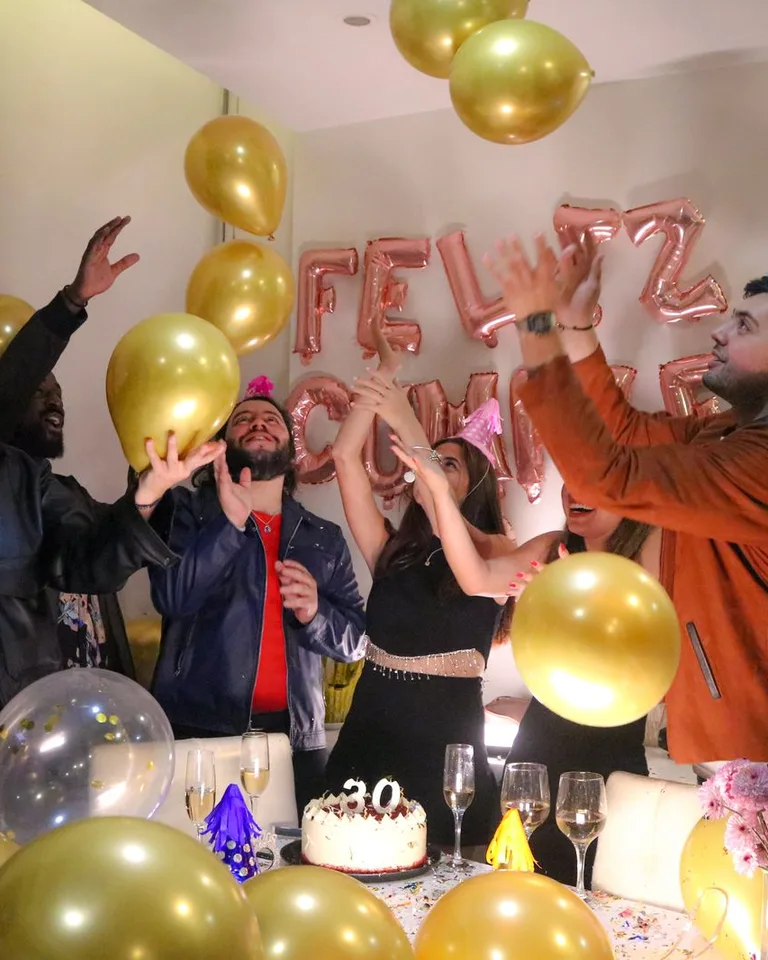 Vibrant birthday party with friends celebrating among balloons and festive decorations