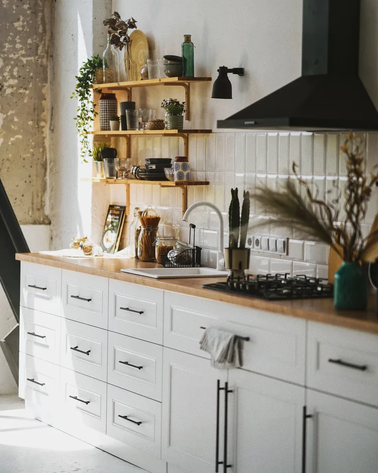 Airy Scandinavian-style kitchen with wooden shelves